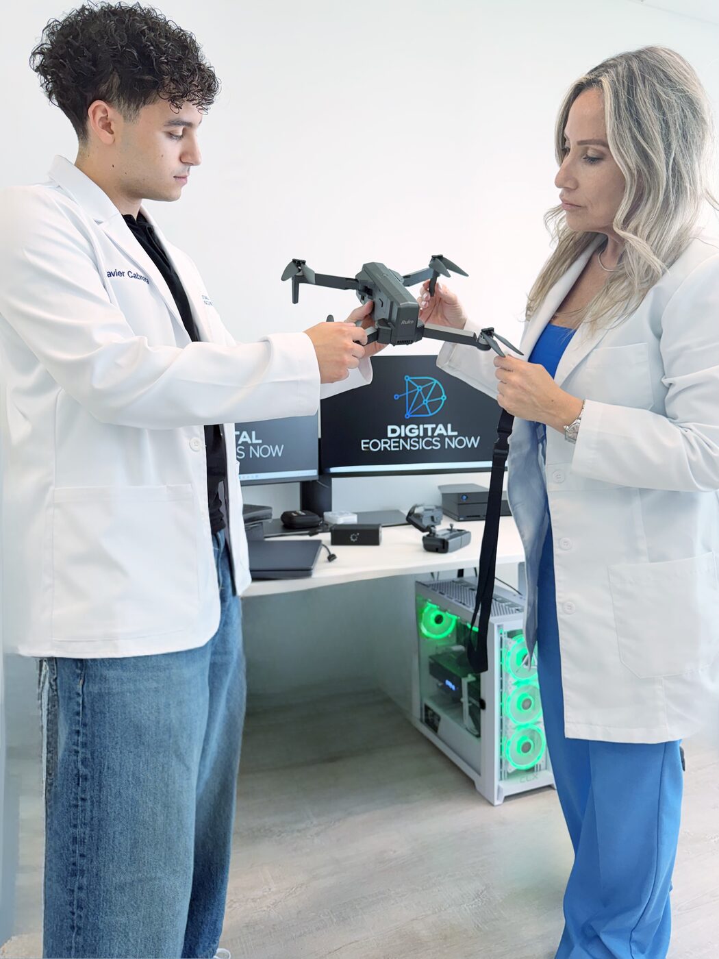 DFN examiners handling an unmanned aircraft in the lab ahead of a flight log and telemetry extraction