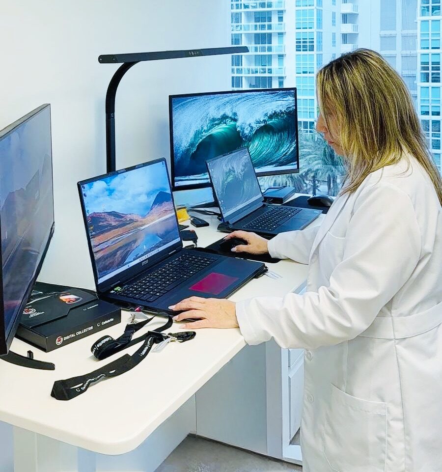Jovianna Gonzalez examining evidence at a forensic acquisition workstation with multiple analysis machines