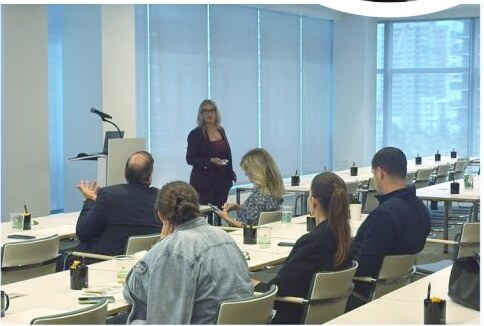 Jovianna Gonzalez presenting a professional training session on crypto money laundering to a seated audience